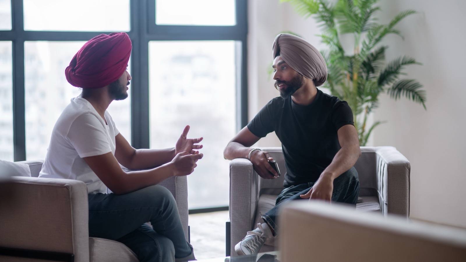 Two men having a calm, attentive talk at home