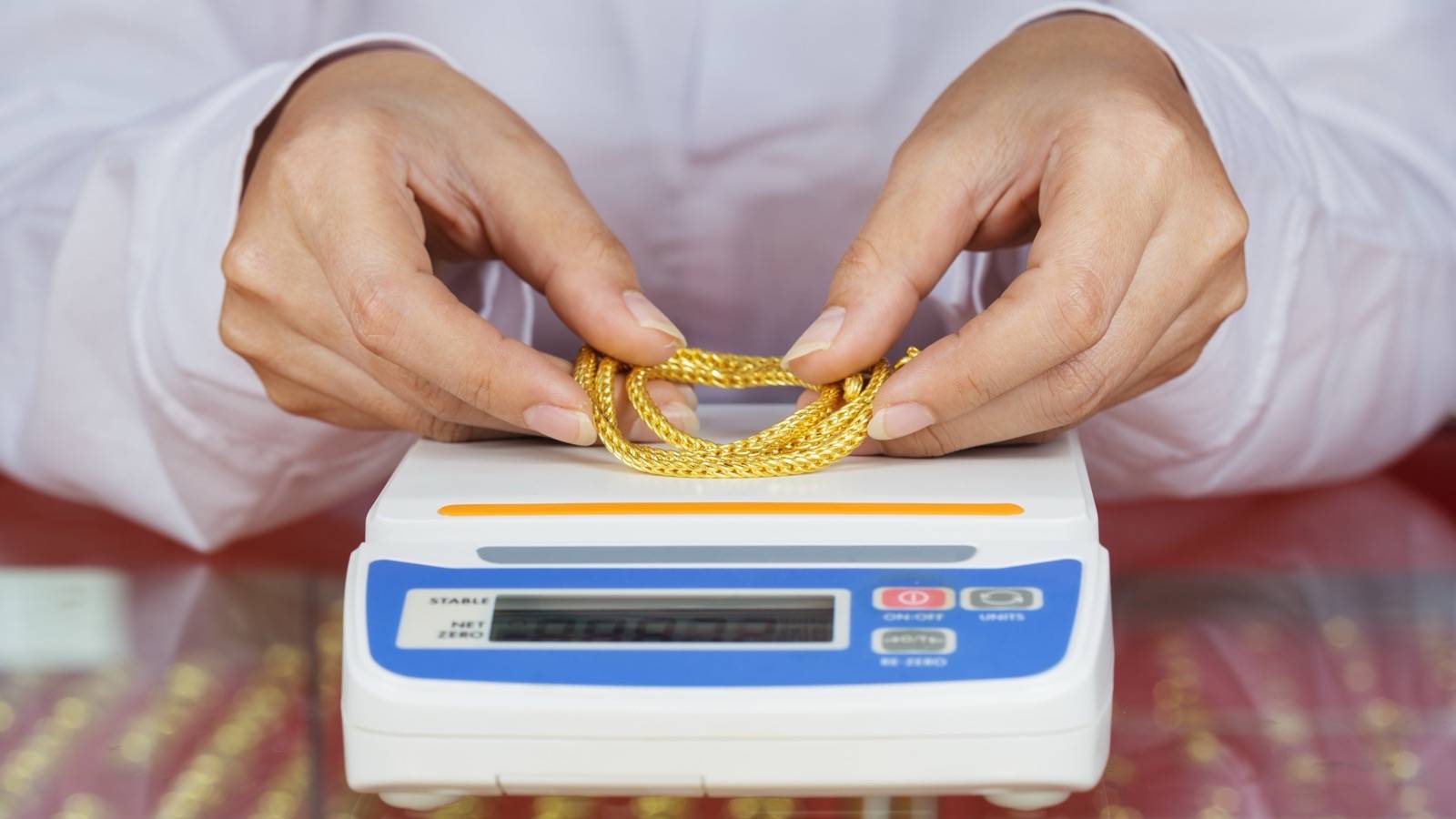 Gold chain being weighed on a digital scale