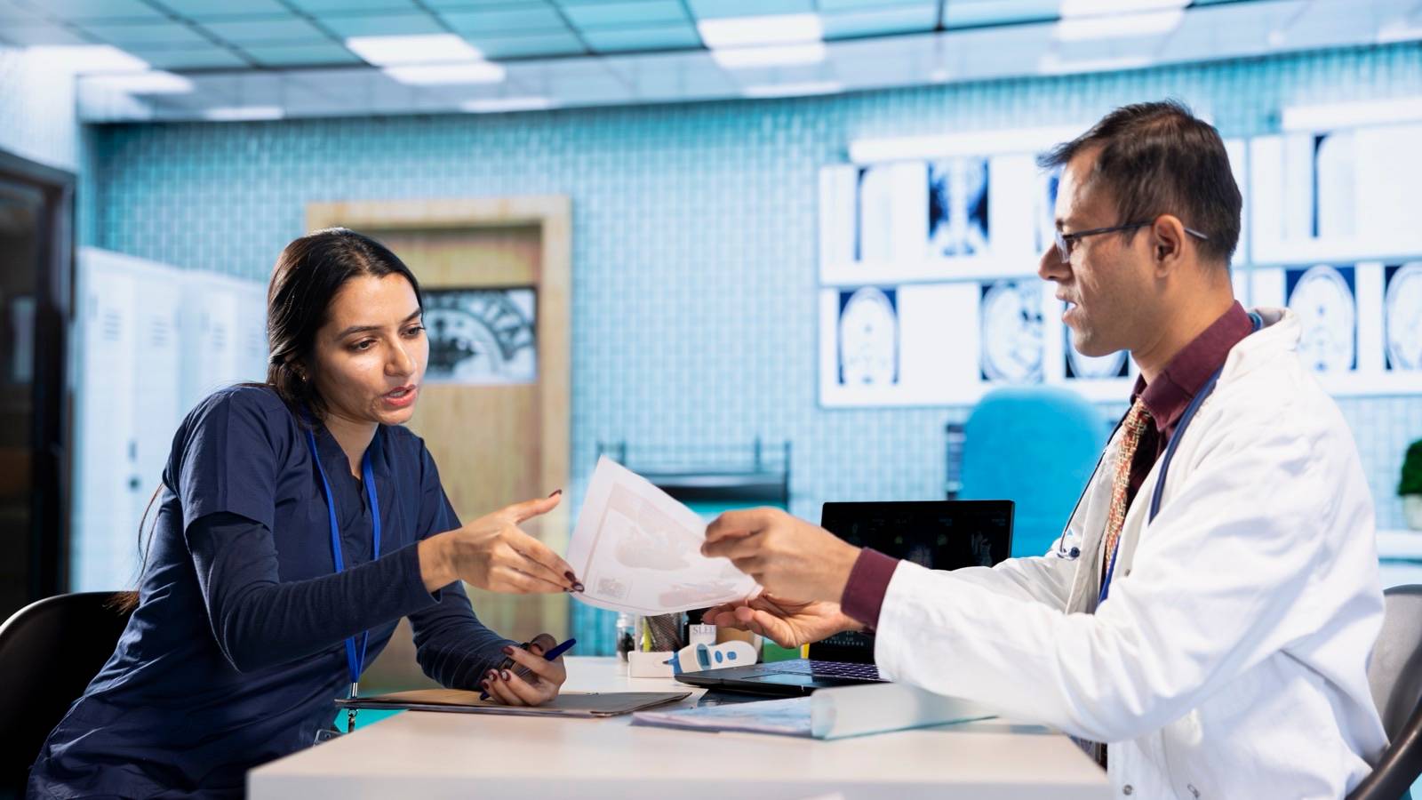 Woman talking with a doctor across a hospital desk